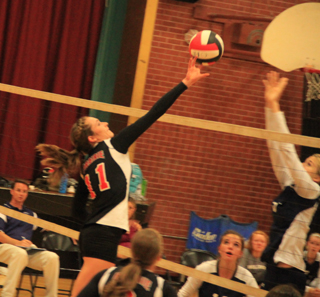 Krystin Uhlenkott tips the ball away from a Grangeville blocker. At the bottom of the photo is Hailey Danly.