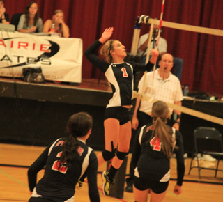 Leah Holthaus spikes the ball against Grangeville. Also shown are Natasha Gimmeson, 2, and Shayla VonBargen, 4.
