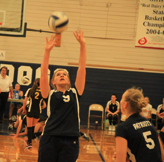 Rachael Frei sets the ball during the Grangeville Tournament. At right is Ally Hale.