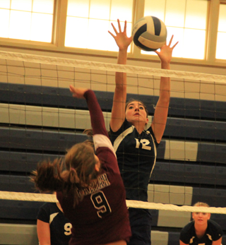 Megan Seubert puts up a wall against a Kamiah spike attempt at the Grangeville Tournament.
