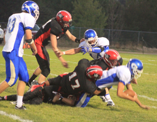 One of 9 sacks of the Genesee quarterback by the Prairie defense. Making the tackle are Tyler Hankerson and Lucas Arnzen. Also shown is Jake Bruner.