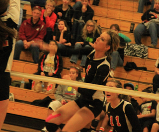 Leah Holthaus slams the ball against Pomeroy at the Border Battle. Behind her is Krystin Uhlenkott.