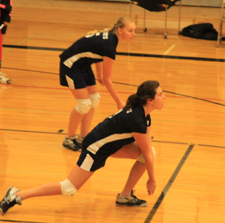 Megan Rehder digs a serve against Highland. Also shown is Ally Hale.