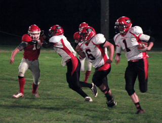 Rhett Schlader makes a block and Dakota Wilson is ready to pick off the next defender as Lucas Arnzen went on to go 78 yards for the games first touchdown.