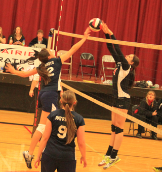 Prairies Shayla VonBargen and Summits Megan Seubert battle at the net as Summits Rachael Frei watches.