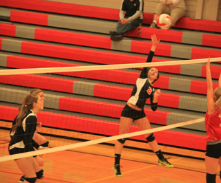 Natasha Gimmeson is usually a setter but got to spike the ball on this play. At left are Shayla VonBargen and Krystin Uhlenkott.