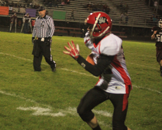 Tannor Ross returns the ball after making an interception on defense at Kamiah.