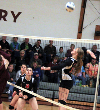 Kayla Schumacher winds up for a kill at Kamiah as Hailey Danly and Natasha Gimmeson watch.