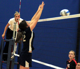 Megan Seubert goes for a block.