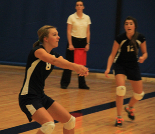 Sarah Chmelik makes a pass as Megan Seubert watches.