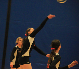 Normally a setter, Hailey Danly got a chance to hit against Troy. Also shown are Leah Holthaus and Kyndahl Ulmer.