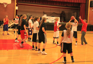 Coach Lori Mader sets up the white shirts to run an opponent’s offense while the dark shirts look to defend it. Shown from left are Sky Wilson, Hailey Danly, Kyndahl Ulmer, Kayla Schumacher, Shayla VonBargen, Krystin Uhlenkott, Keely Schmidt, Leah Holthaus, Nicole Wemhoff and Natasha Gimmeson.