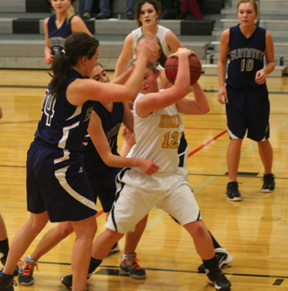 A Highland player gets double-Megan’d as Megan Rehder, 24, and Megan Seubert play defense. In the background are Ally Hale and Sarah Chmelik, 10. Photo by Steve Wherry.
