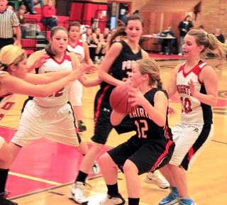 Keely Schmidt, 3, and Sky Wilson battle an Orofino player for the ball. At right is Leah Holthaus.