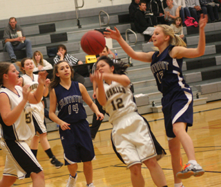 Summit’s Rachel Waters, 14, and Ashlee Stubbers, 12, play defense against Highland. Photo by Steve Wherry.