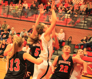 Krystin Uhlenkott puts up a shot against Kendrick. At right is Shayla VonBargen while partially hidden at left is Hailey Danly.