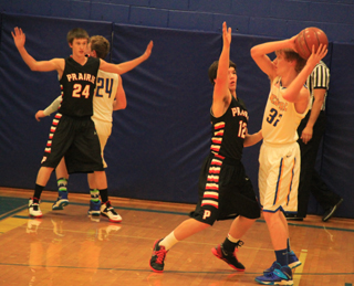 Dylon Bruegeman, 24, and Terran Peery, 12, play defense against Nezperce.