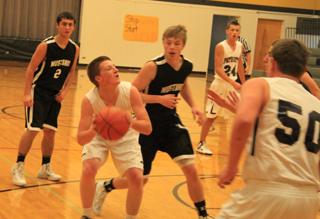 Josh Lustig handles the ball against Deary. Also shown are Michael Waters and Chris Osborne, 50.