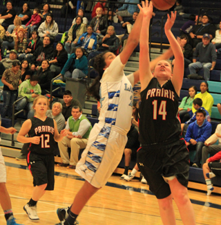 A Lapwai player attempts to block Kayla Schumachers shot as Nicole Wemhoff watches.