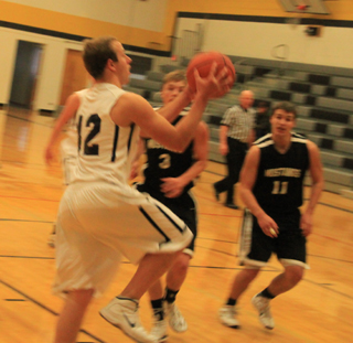 Summits Matthew Schwartz drives in for a lay-up against Deary.