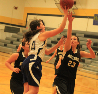Summits Megan Rehder shoots from the low block against Deary.