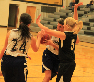 Summits Megan Seubert battles a Deary defender as Megan Rehder, 24, watches.