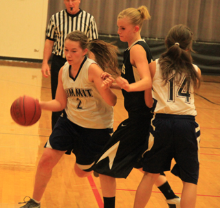 Rachael Frei dribbles the ball as Rachel Waters sets a pick against the Deary defender.