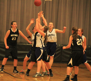 Summit players battle Deary for a rebound on the defensive end. From left are Megan Seubert, Rachael Frei, Ally Hale and Sarah Chmelik.