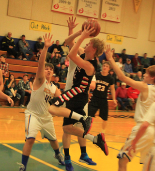 Rhett Schlader goes into the lane for a shot. In the background is Lucas Arnzen.