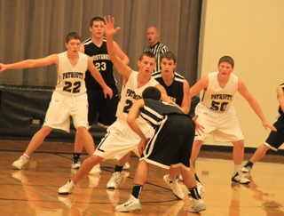 Summit plays defense against Deary. From left are Patrick Chmelik, Michael Waters and Chris Osborne.