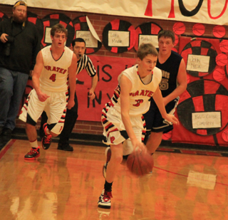 Bryson Higgins brings the ball upcourt against Grangeville as Isaiah Shears trails the play.