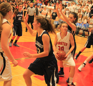 Krystin Uhlenkott looks for an opening against Grangeville. At left is Keely Schmidt.