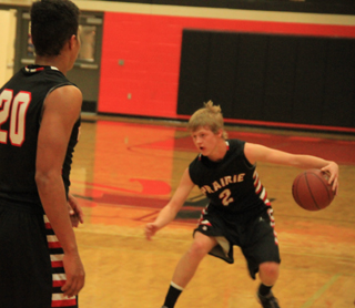 Rhett Schlader handles the ball at Troy. At left is Tyler Hankerson.