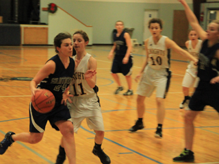 Megan Rehder tries to get past a Logos defender. At right is Ally Hale while Rachael Frei can be seen in the background.