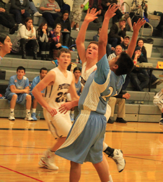 Josh Lustig found the going tough inside against Lapwai. Also shown is Patrick Chmelik.