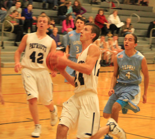 Michael Waters goes for a lay-up against Lapwai. Also shown is Matt Schwartz.