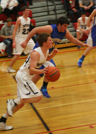 Josh Lustig drives upcourt against Nezperce. In the background is Patrick Chmelik. Photo by Steve Wherry.