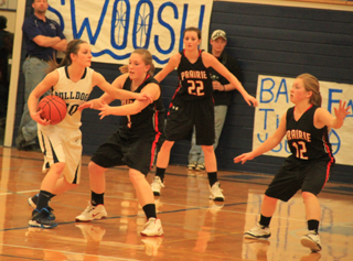 Keely Schmidt tries to poke the ball away from a Grangeville player. Also shown are Kyndahl Ulmer, 22, and Nicole Wemhoff, 12.