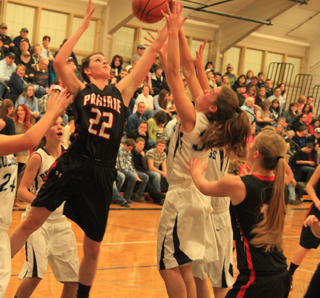 Kyndahl Ulmer battles for a rebound at Grangeville. At right is Kayla Schumacher.