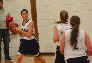 Megan Seubert looks to make a pass in the Summit girls game against Nezperce. At right are Sarah Chmelik and Rachael Frei. Photo by Steve Wherry.