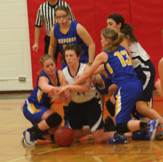 Are they playing pattycake or gaoing after the ball? Megan Rehder goes after a loose ball in the Nezperce game. Megan Seubert is at right. Photo by Steve Wherry.