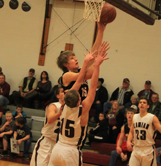 Tanner Ross goes for a lay-up at Kamiah. Dylon Bruegeman can be seen in the background at right.