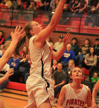 Keely Schmidt goes for a lay-up against Genesee as Krystin Uhlenkott watches.