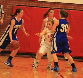 Nicole Wemhoff fights through a screen on defense against Genesee. Also shown is Kyndahl Ulmer.