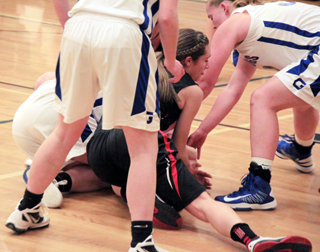 Krystin Uhlenkott goes after a loose ball along with several Genesee players.
