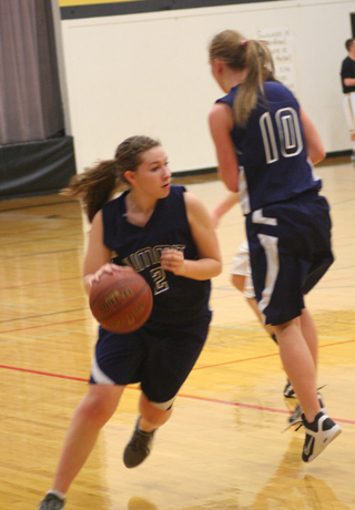 Rachael Frei drives past a pick set by Sarah Chmelik in Summits game at Highland last Thursday, Photo by Steve Wherry.