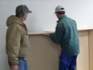 Bob Daily and Brent Goeckner work on the new shelving in the Library. Photo provided by Laurine Nightingale.