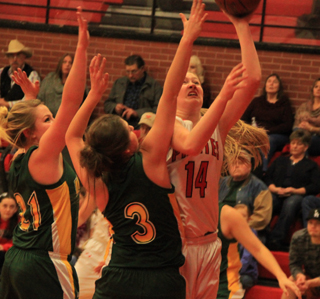 Kayla Schumacher goes for a shot against 2 defenders in the Potlatch game.