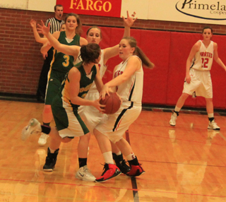 Keely Schmidt tries to take the ball away as she and Hailey Danly trap a Potlatch player. In the back is Kyndahl Ulmer.