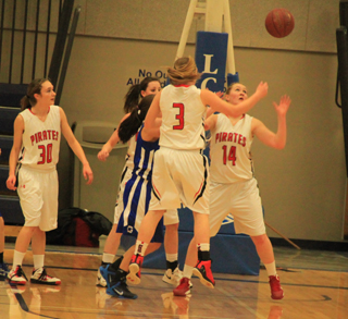 Keely Schmidt, 3, has just knocked the ball loose from a Genesee player and Kayla Schumacher is about to gather it in for the turnover. Krystin Uhlenkott is shown at left. In the background is Kyndahl Ulmer.